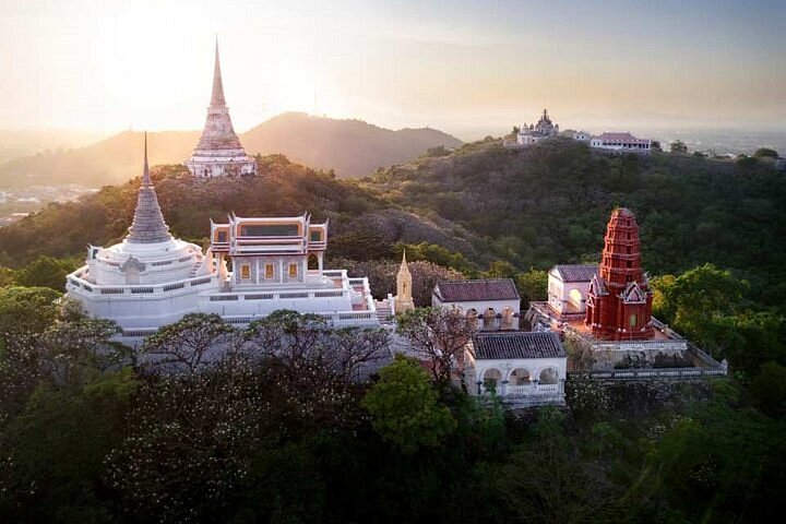 Phra Nakhon Khiri hilltop palace and temple buildings above Phetchaburi at sunset