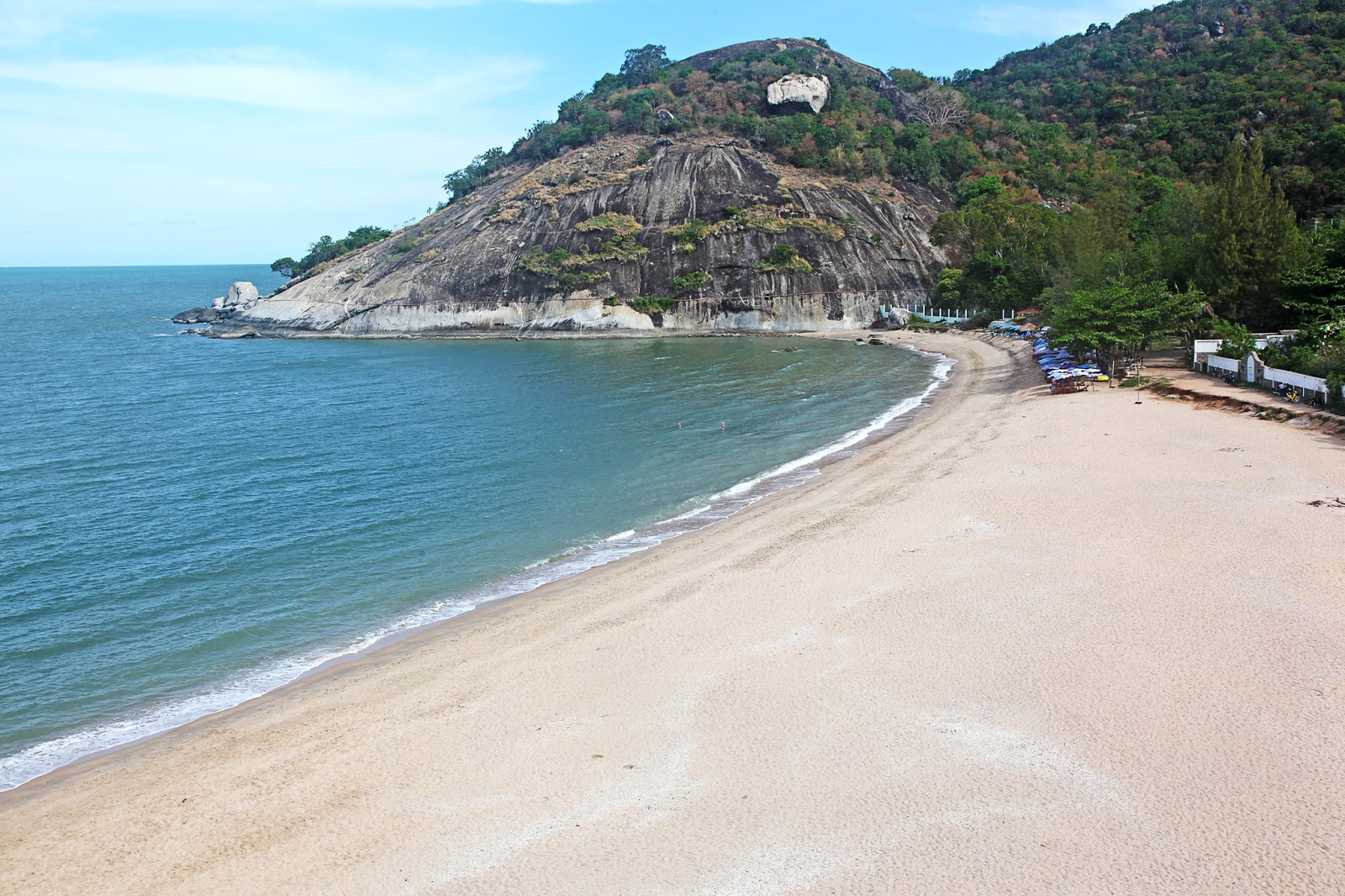 Sai Noi Beach south of Hua Hin, a curved bay of pale sand below a rocky headland